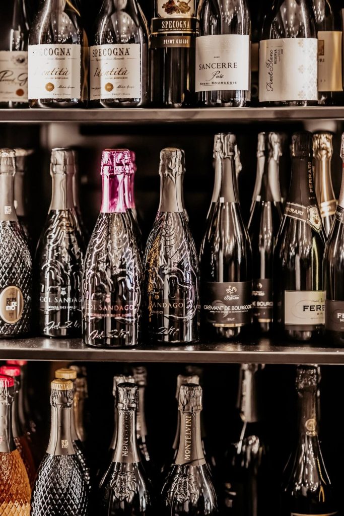 detailný záber na kvalitné Prosecco a Champagne v otvorenej chladničke
